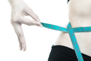 Weight Loss. Blue Measuring Tape On Woman Body
